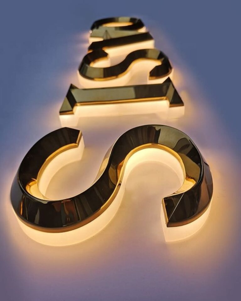 Gold mirror finish letters with warm LED halo lighting