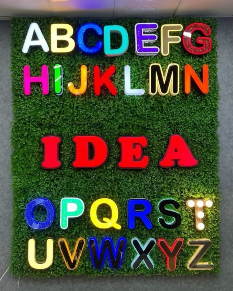 Wall of LED letter style samples on a green grass panel