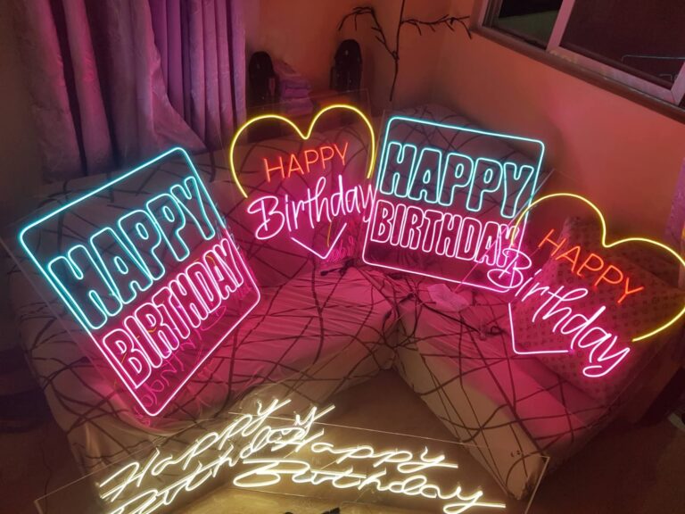 Custom Happy Birthday neon signs in pink blue and yellow