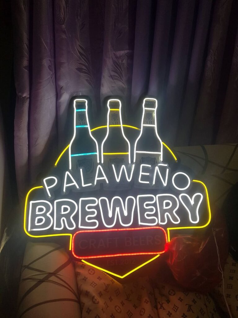 Brewery logo neon sign with three bottles in white yellow and red